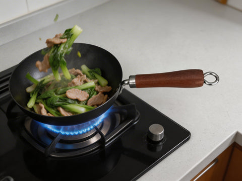 Frying pan with vegetables and meat on a gas stove